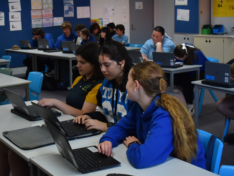 Secondary students working on their individually assigned laptops