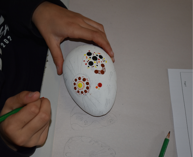 student painting emu egg