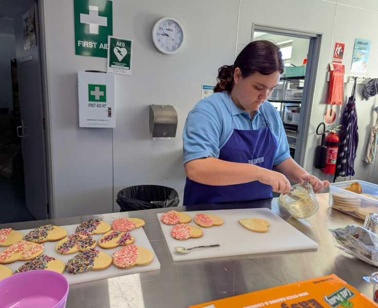 Big Picture student decorating biscuits for primary mothers day celebration