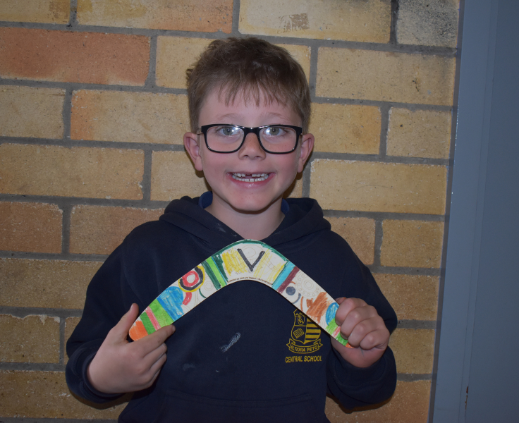 Student proudly showing his art work during NAIDOC week
