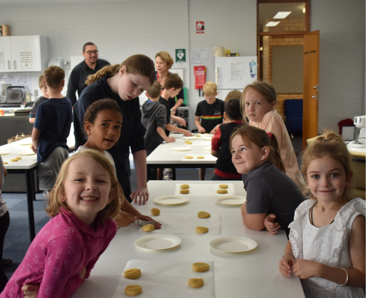 Primary students cooking biscuits during PBL rewards session