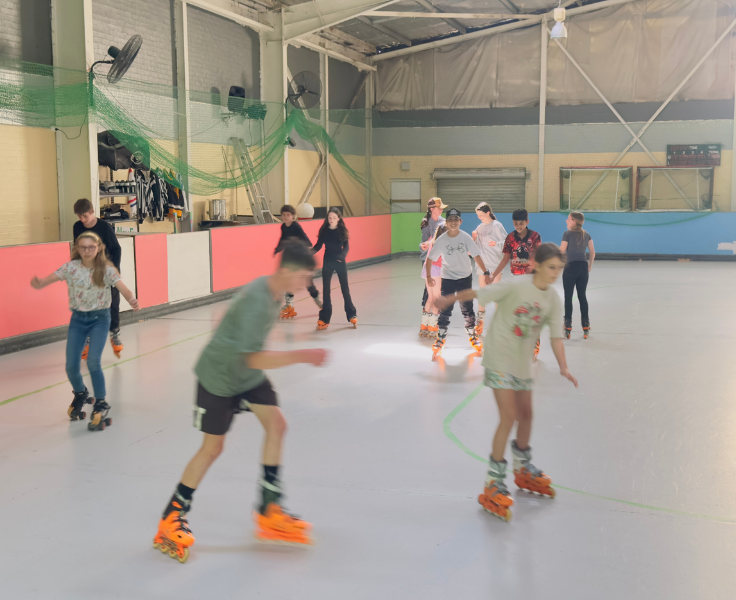 Secondary students rollerblading at PBL rewards day