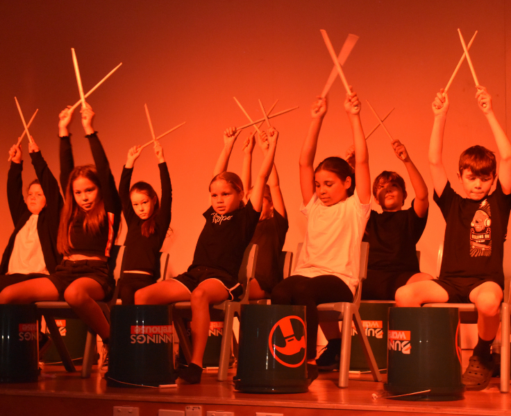 Class performing a drumming item at our performing arts night