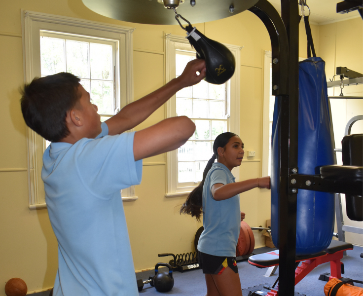 Students using the indoor fitness gym equipment